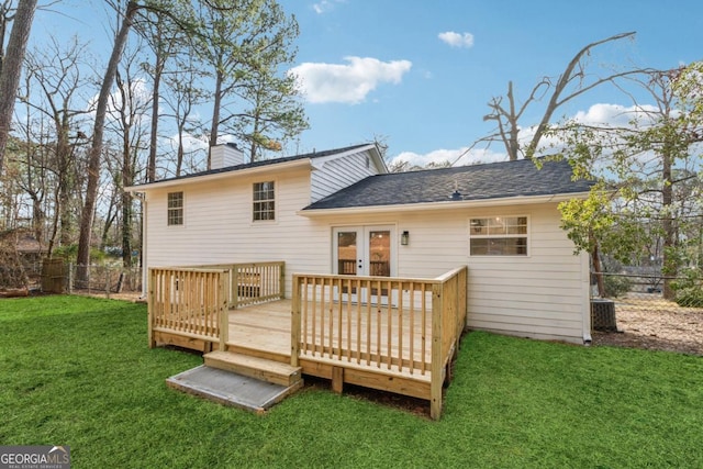 rear view of house with central AC unit, a lawn, french doors, and a deck