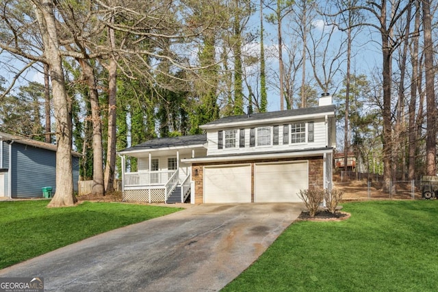 view of front of home featuring a garage, covered porch, and a front yard