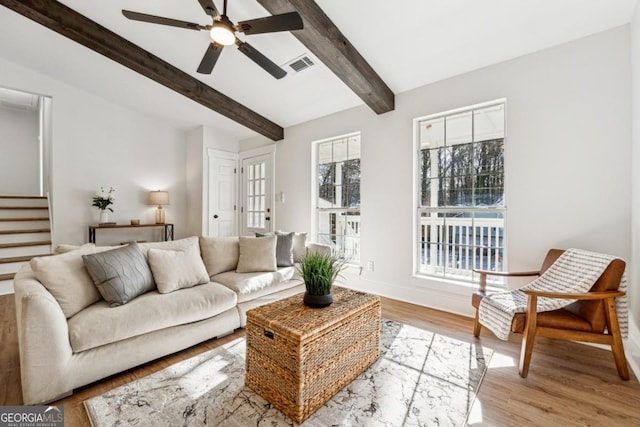 living room with beam ceiling, light hardwood / wood-style flooring, and ceiling fan