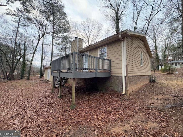 view of home's exterior with a wooden deck