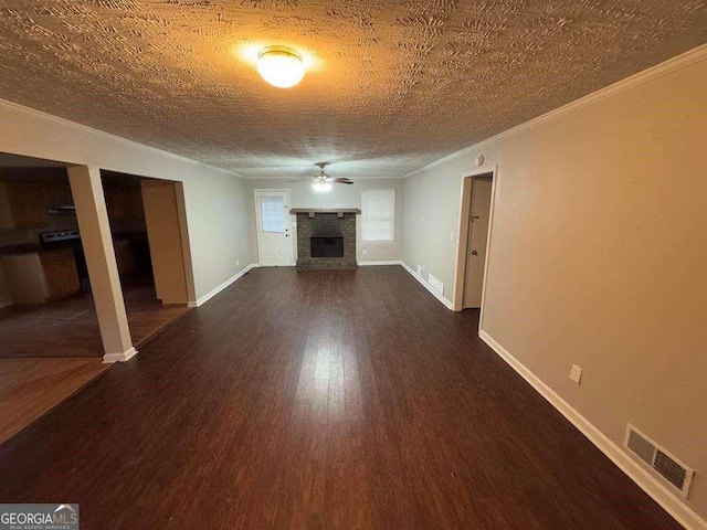 unfurnished living room featuring a textured ceiling, ornamental molding, dark hardwood / wood-style floors, and ceiling fan