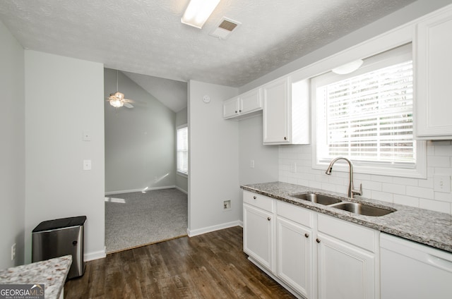 kitchen featuring tasteful backsplash, white cabinetry, sink, ceiling fan, and light stone counters