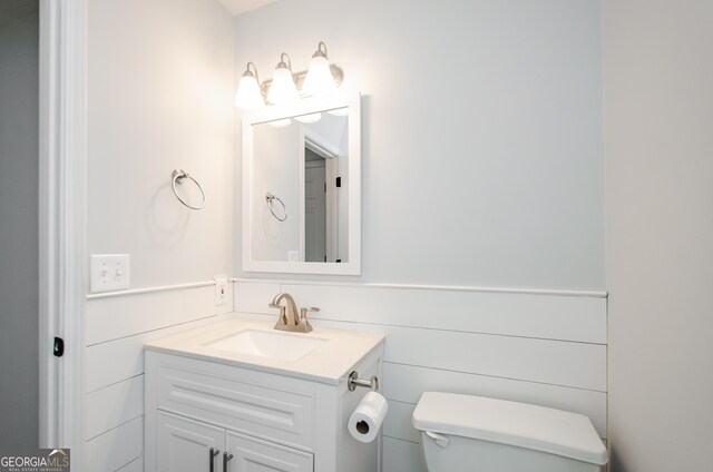 bathroom featuring vanity and toilet