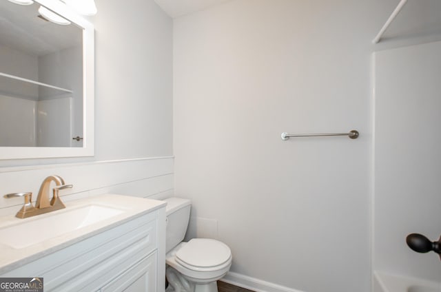 bathroom with vanity, wood-type flooring, a shower, and toilet