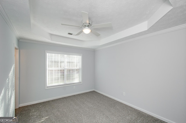 carpeted empty room with crown molding, ceiling fan, a tray ceiling, and a textured ceiling