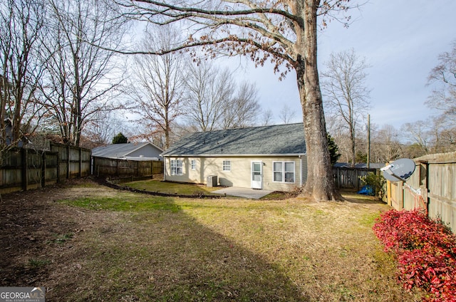 back of house featuring a patio and a yard