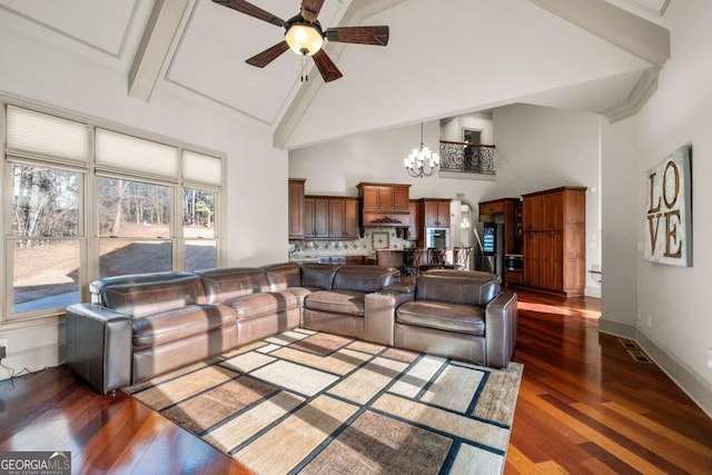 living room featuring ceiling fan with notable chandelier, dark hardwood / wood-style floors, and high vaulted ceiling