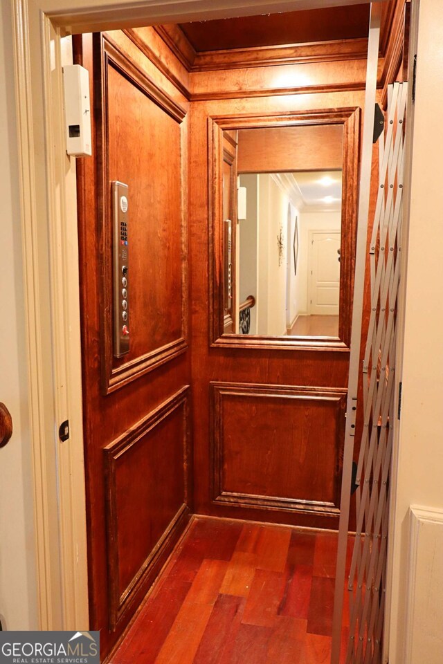 room details featuring hardwood / wood-style floors, crown molding, and elevator