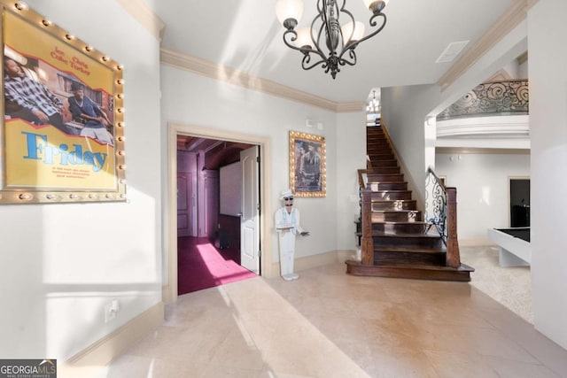 foyer featuring ornamental molding and a chandelier