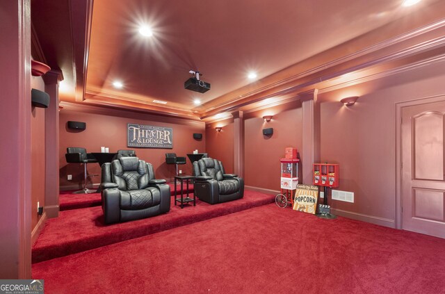 carpeted home theater with crown molding and a raised ceiling