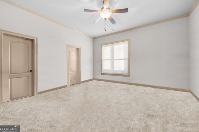 unfurnished bedroom with crown molding, carpet, and ceiling fan