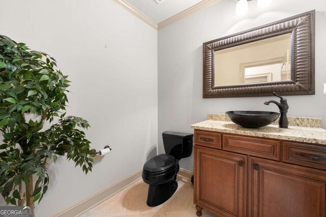 bathroom featuring vanity, tile patterned floors, ornamental molding, and toilet