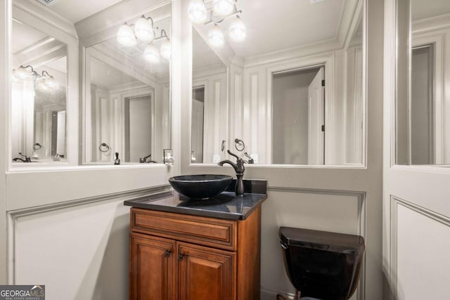 bathroom featuring ornamental molding and vanity