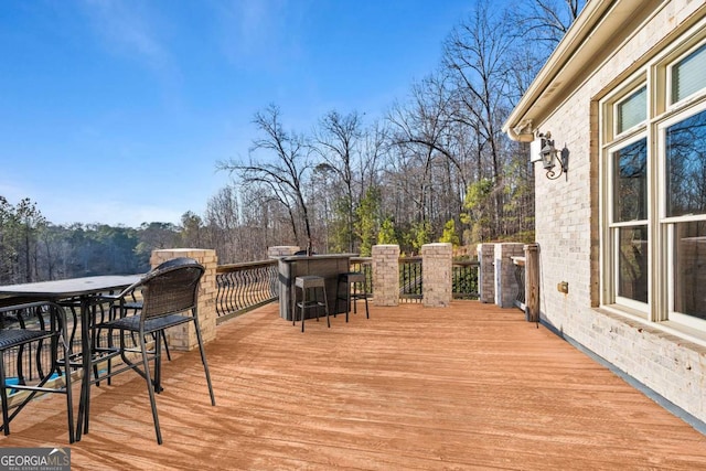 wooden terrace featuring exterior bar