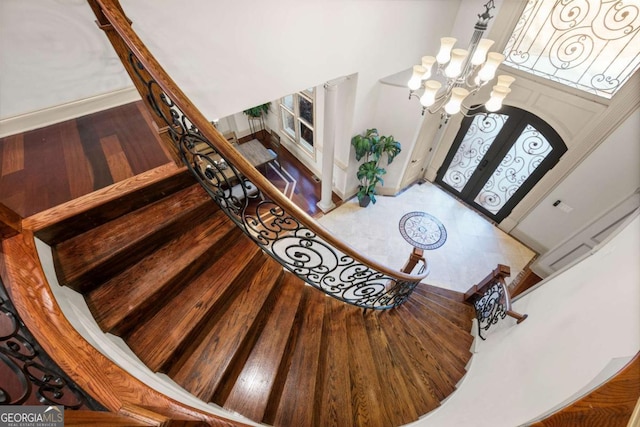 foyer featuring an inviting chandelier and hardwood / wood-style flooring