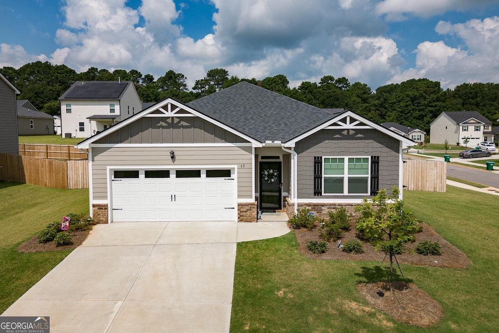 craftsman-style home featuring a garage and a front yard