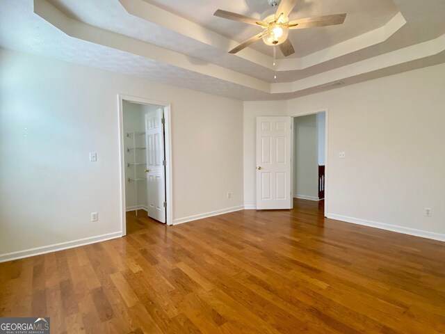 4299 High Country Dr, Douglasville, GA 30135 - unfurnished room featuring ceiling fan, a raised ceiling, and hardwood / wood-style floors