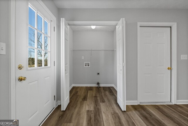 clothes washing area with a healthy amount of sunlight, washer hookup, dark hardwood / wood-style floors, and electric dryer hookup