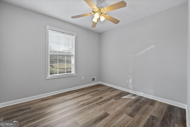 unfurnished room with wood-type flooring, a textured ceiling, and ceiling fan