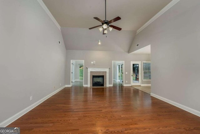 unfurnished living room featuring hardwood / wood-style floors, high vaulted ceiling, ornamental molding, and ceiling fan