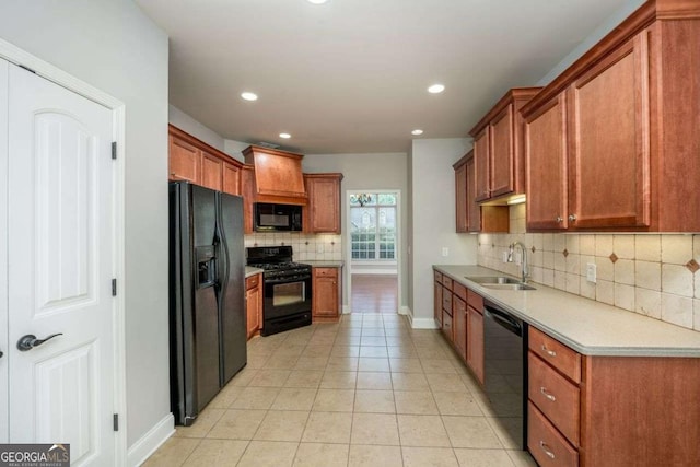 kitchen featuring light tile patterned flooring, sink, decorative backsplash, and black appliances