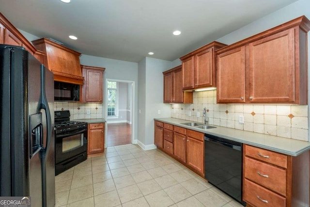 kitchen with sink, light tile patterned floors, decorative backsplash, and black appliances