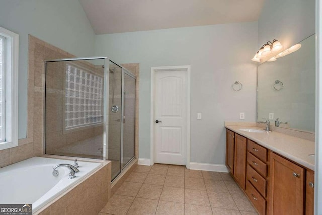 bathroom with vaulted ceiling, vanity, plus walk in shower, and tile patterned flooring