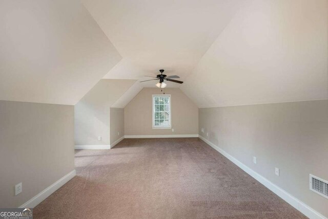 bonus room featuring light carpet, vaulted ceiling, and ceiling fan