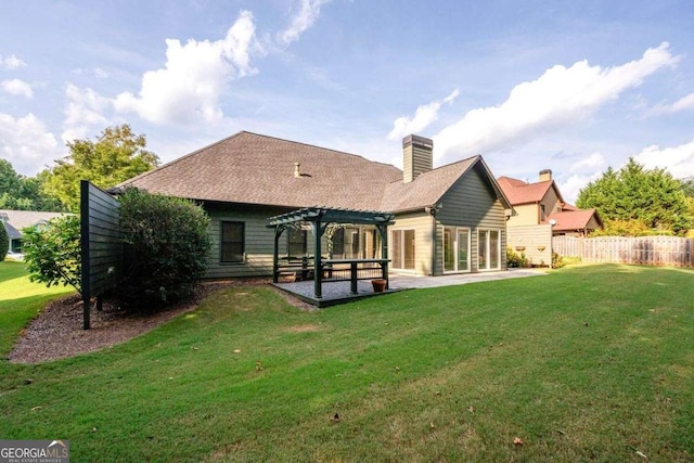 rear view of house featuring a patio, a yard, and a pergola