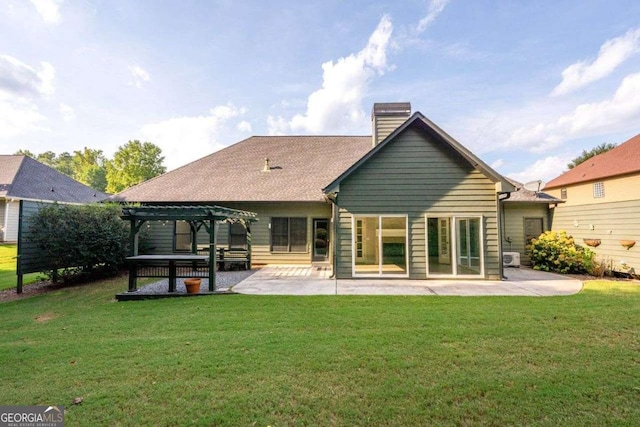 rear view of property with a pergola, a patio, and a lawn