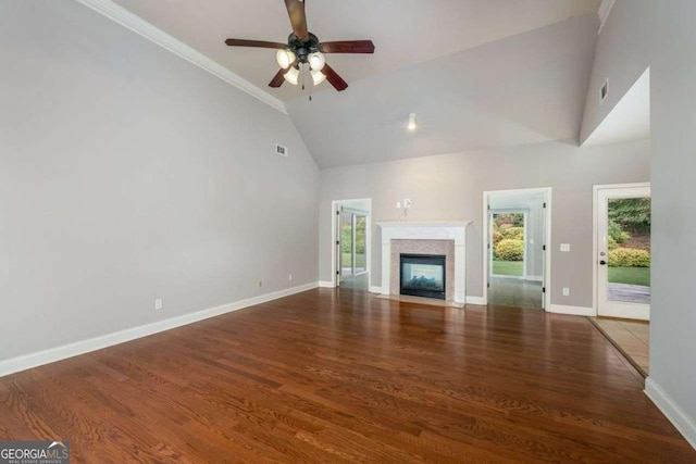 unfurnished living room with ceiling fan, dark hardwood / wood-style flooring, and high vaulted ceiling