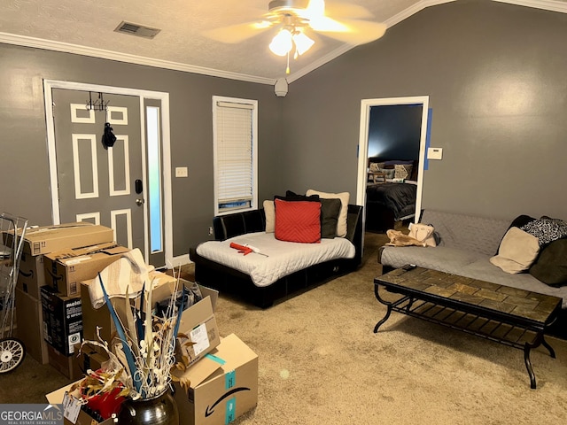 living room featuring vaulted ceiling, ornamental molding, carpet, ceiling fan, and a textured ceiling