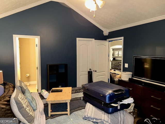 bedroom featuring crown molding, lofted ceiling, and connected bathroom