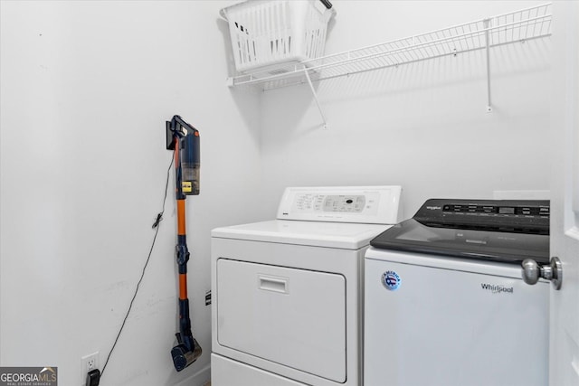 laundry room with washing machine and clothes dryer