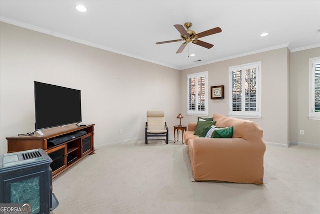 living room with carpet floors, ornamental molding, and ceiling fan