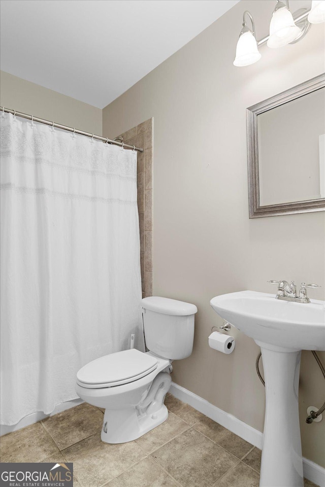 bathroom featuring tile patterned flooring, sink, toilet, and a shower with shower curtain