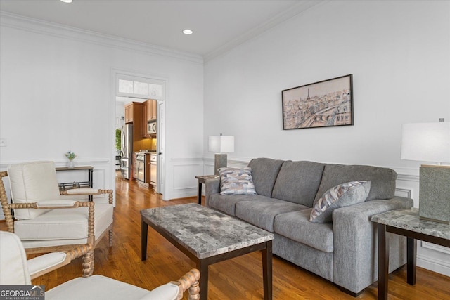 living room with hardwood / wood-style floors and crown molding