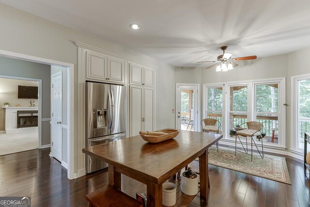 kitchen with ceiling fan, dark hardwood / wood-style flooring, stainless steel fridge with ice dispenser, and white cabinets