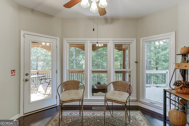 interior space with ceiling fan and dark hardwood / wood-style flooring