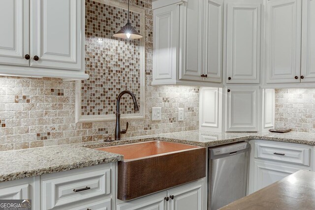 kitchen featuring decorative light fixtures, dishwasher, sink, and white cabinets