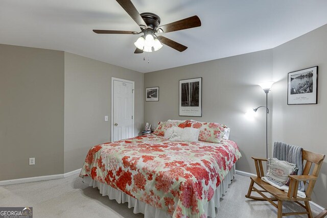 bedroom featuring light carpet and ceiling fan