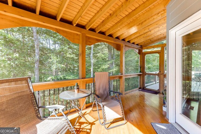 sunroom with vaulted ceiling with beams and wood ceiling