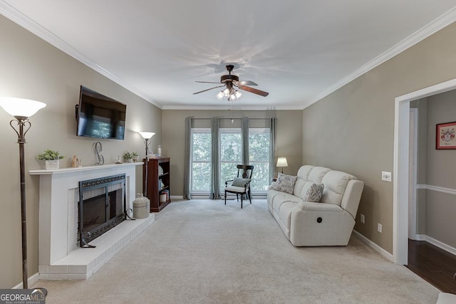 living room featuring light carpet, a brick fireplace, ornamental molding, and ceiling fan