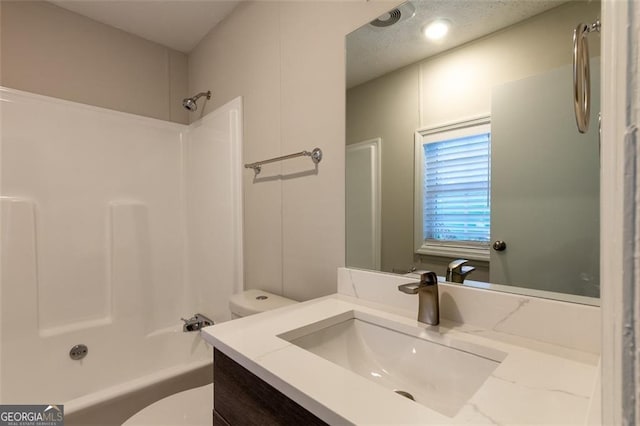 full bathroom featuring vanity, tub / shower combination, and toilet