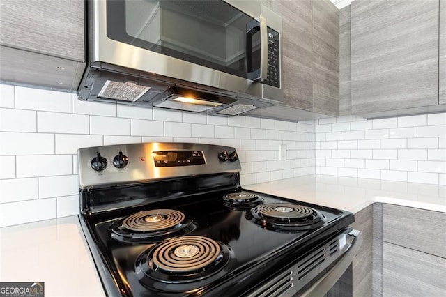 kitchen featuring appliances with stainless steel finishes and decorative backsplash