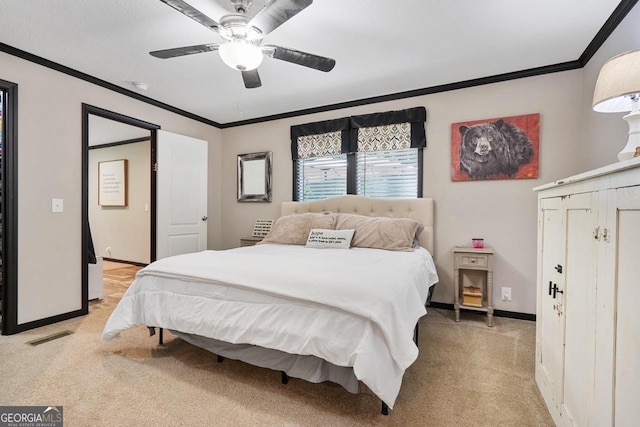 carpeted bedroom with crown molding and ceiling fan