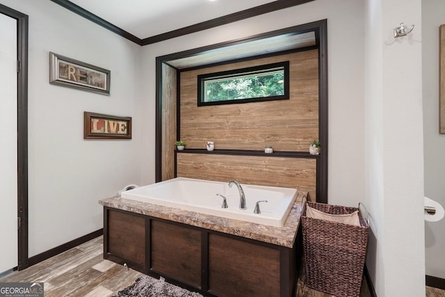 bathroom featuring a tub to relax in, crown molding, and hardwood / wood-style floors