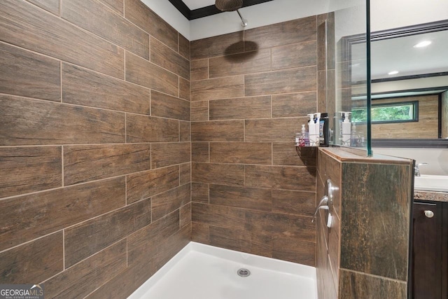 bathroom featuring vanity and tiled shower