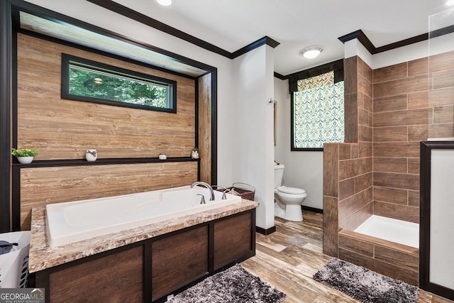 bathroom with hardwood / wood-style flooring, ornamental molding, independent shower and bath, and toilet