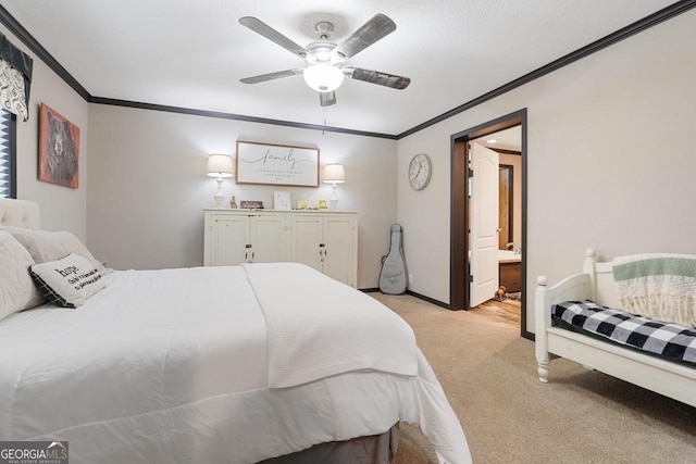 carpeted bedroom with connected bathroom, ornamental molding, and ceiling fan